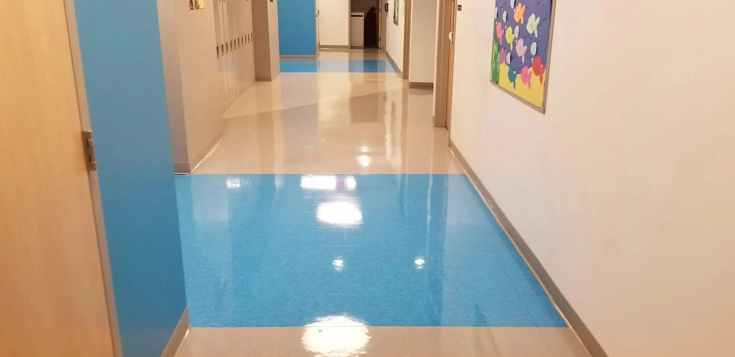 Freshly cleaned and polished corridor floor in a school building maintained by Modular Concepts