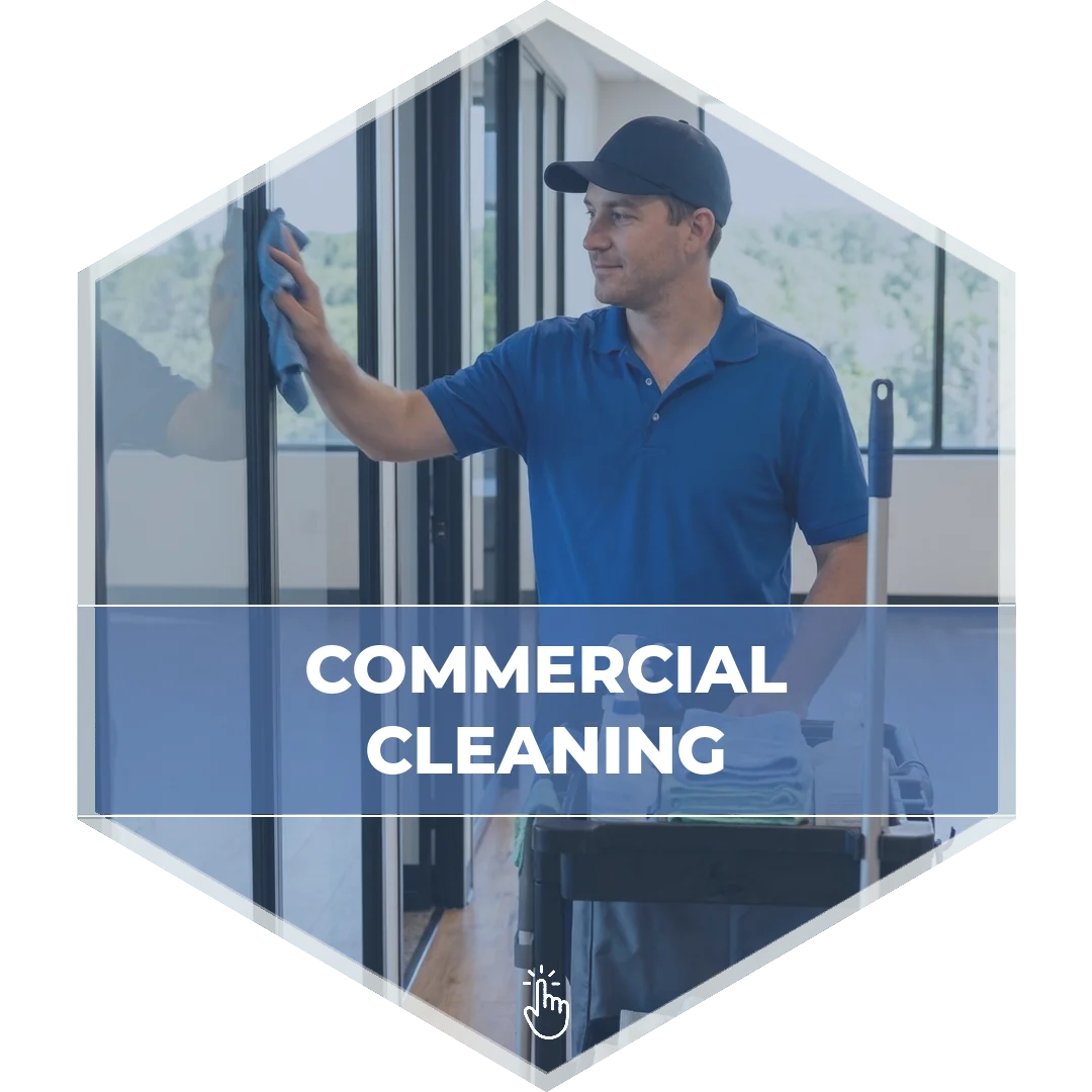 Modular Concepts commercial cleaning technician wiping down glass office partitions beside a supply cart in a modern Massachusetts commercial building
