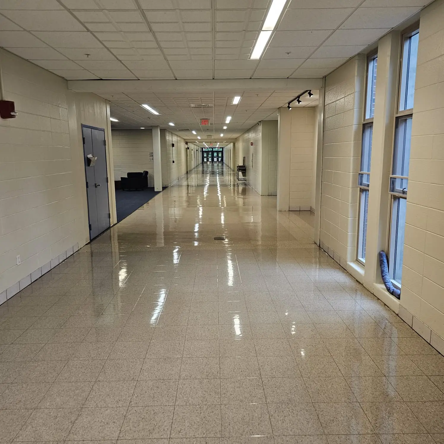 Freshly refinished school hallway floor, completely dry with a mirror shine