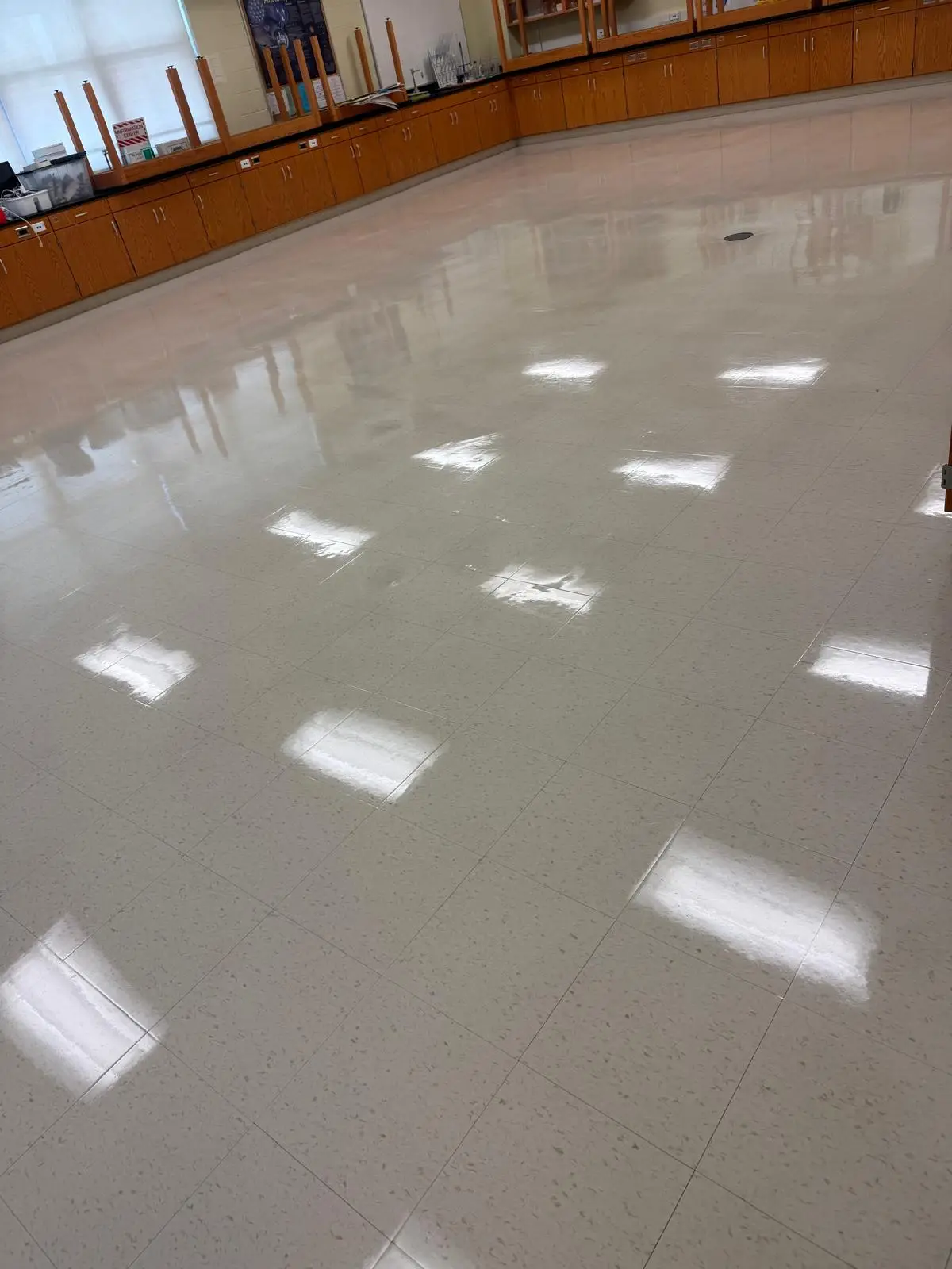 Science lab floor after strip and wax refinishing around fixed benches