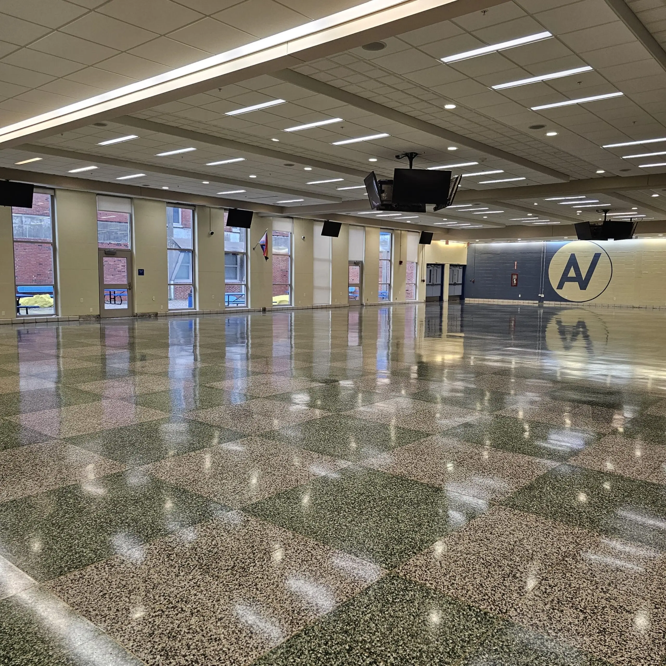 Checkered terrazzo cafeteria floor from the window side after refinishing