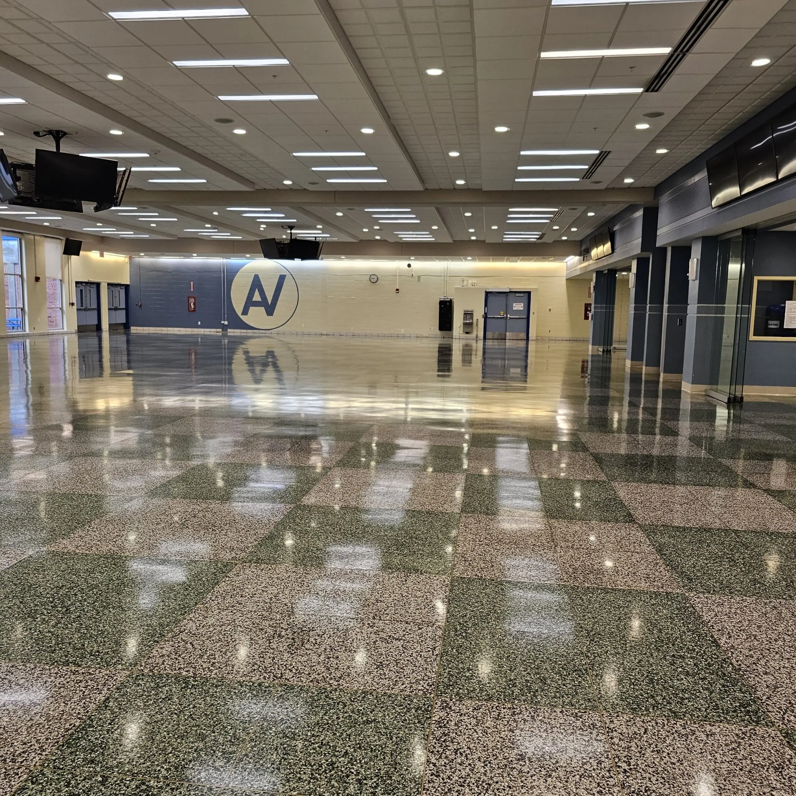 Terrazzo cafeteria floor after summer refinishing with deep reflections
